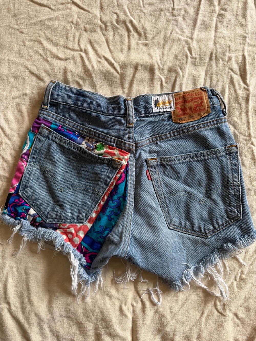 Vintage Levi's Blue Denim Cutoff Shorts with Multicolor Patch Detail